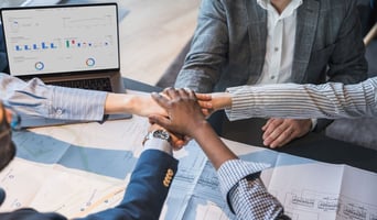 Collaborative Team Uniting in a Professional Business Setting stock photo as post merger integration success concept