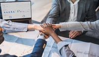 Collaborative Team Uniting in a Professional Business Setting stock photo as post merger integration success concept