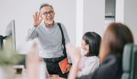 Working asian chinese senior colleague back to work greeting each other in office morning as return to work strategy conceptstock photo