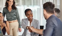 Mature black businesswoman shaking hands with new business partner stock photo.jpg