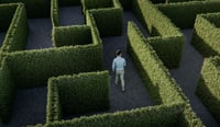 Business man walking in a maze as concept for e-invoicing challenges