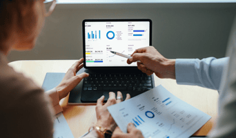 Data on computer screen indicating revenue growth and seamless integration post-acquisition