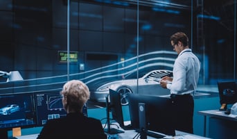 Engineering Research Agency Perform Aerodynamic Testing with a Modern Eco-Friendly Electric Sports Car in a Wind Tunnel. Chief Development Officer Works on a Tablet and Changes Testing Options