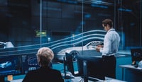 Image for Engineering Research Agency Perform Aerodynamic Testing with a Modern Eco-Friendly Electric Sports Car in a Wind Tunnel. Chief Development Officer Works on a Tablet and Changes Testing Options