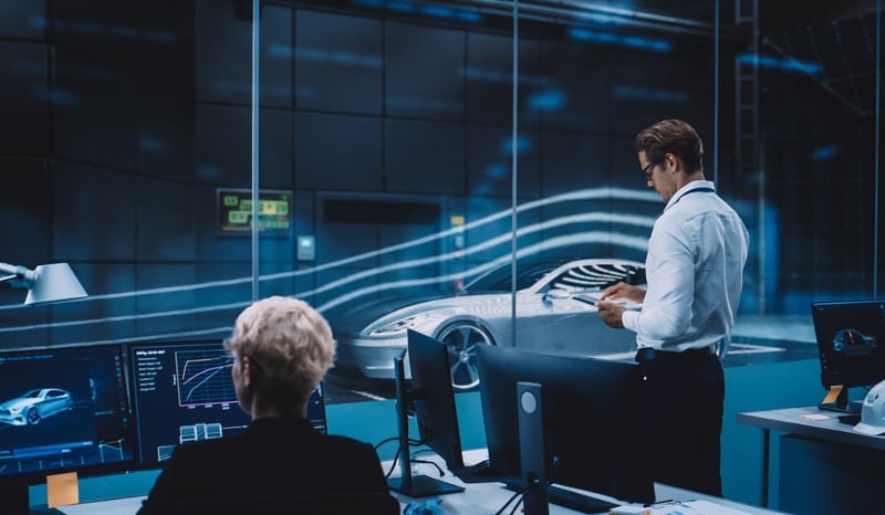 Image for Engineering Research Agency Perform Aerodynamic Testing with a Modern Eco-Friendly Electric Sports Car in a Wind Tunnel. Chief Development Officer Works on a Tablet and Changes Testing Options