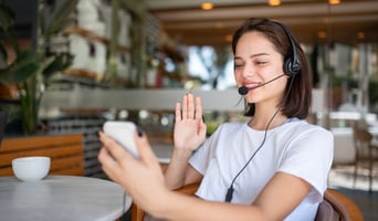 Female Call Center Agent Working in a Café Setting stock photo