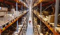 High angle view of a warehouse manager walking with foremen checking stock on racks as sustainable supply chain change management concept stock photo