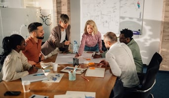 Marketing professionals collaborating on project in modern office stock photo