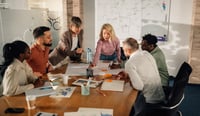 Marketing professionals collaborating on project in modern office stock photo