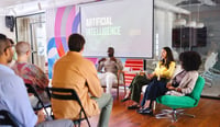 Colleagues talking about AI at product management panel stock photo