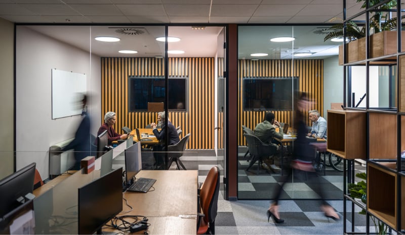 Image for Blurred People Moving Through The Office office transformation concept stock photo.jpg