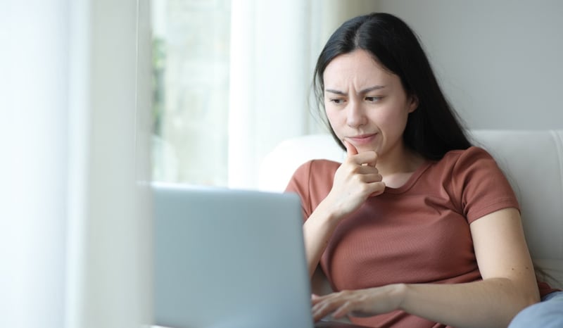Image for Suspicious woman checking laptop content at home stock photo as subscriptions concept.jpg