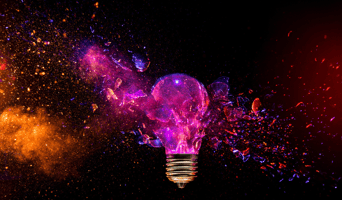 Exploding light bulb concept on dark background stock photo to abstractly demonstrate impact