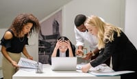 team of people stressed in an office, fear of AI / resistance to AI concept stock photo