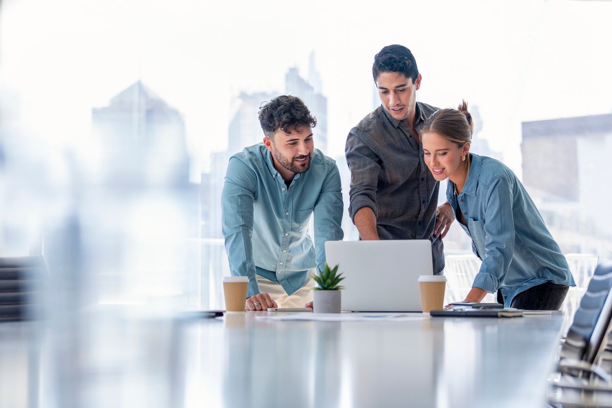 Business team working on a laptop computer stock photo
