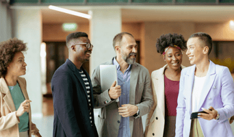 Stock photo of five diverse people in a happy team indicating healthy workplace wellbeing trends